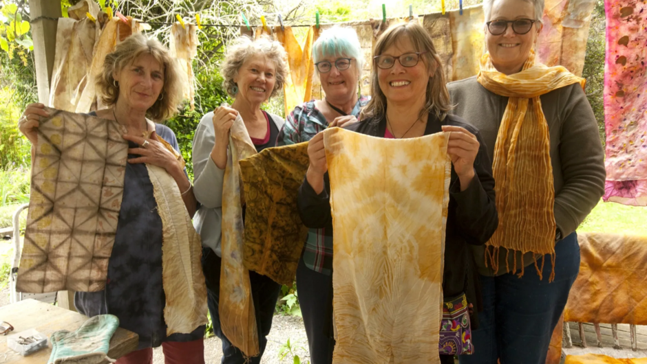 Students proudly hold up their work made at our Eco Dyeing Workshop.