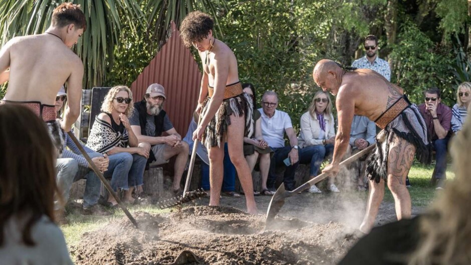 Traditional Hangi in the ground cooked on hot rocks.