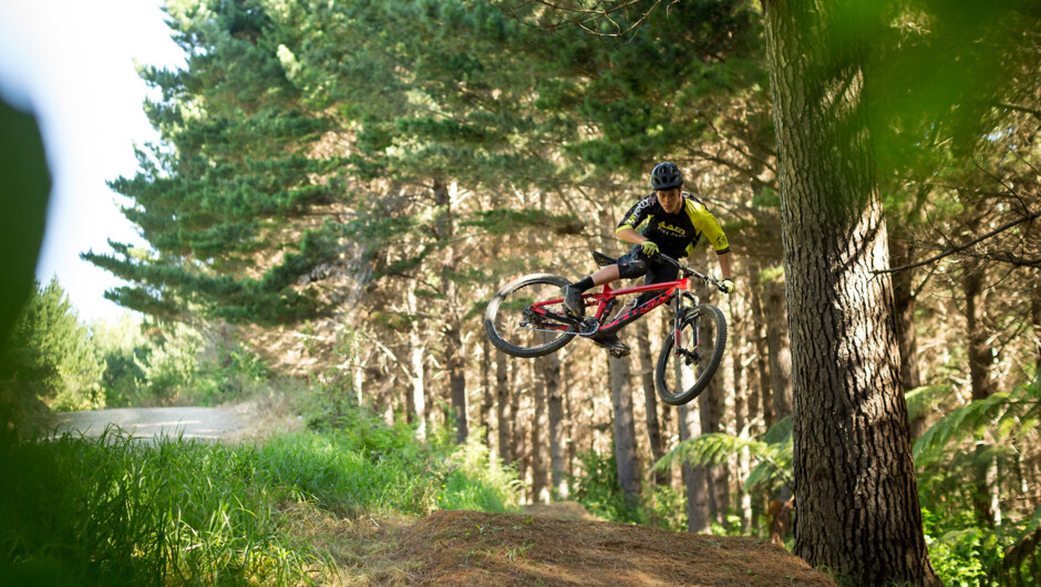 440 rider Matt Berry launching a jump on Pretty Fly trail