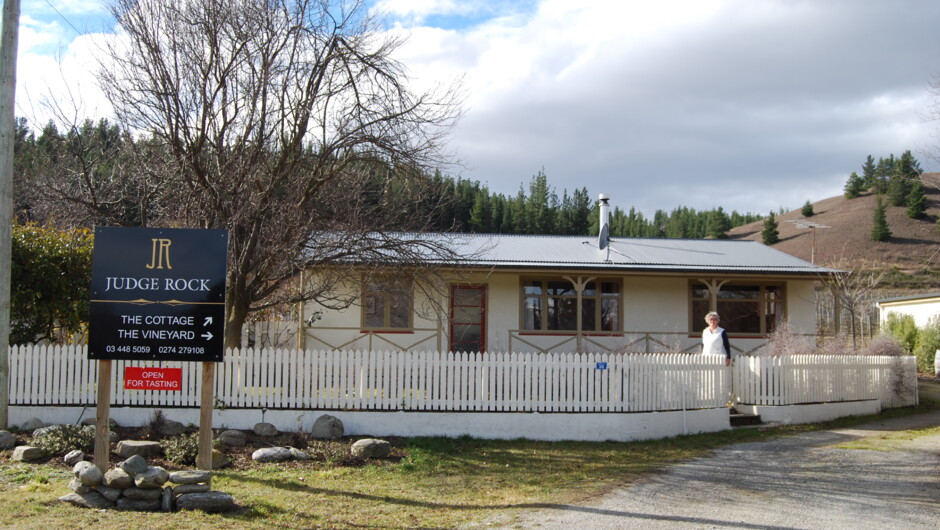 View from the street of the picket fence and your host angela