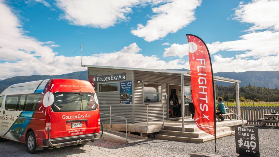 Golden Bay's passenger van parked up next to the Golden Bay Air terminal at Tākaka Airport.